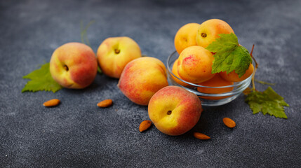 Harvest of peaches for food or juice. fresh organic fruit, vegan food. Large peaches on dark table background, selective focus.