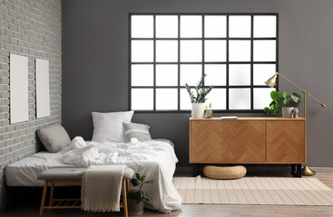 Interior of modern children's bedroom with cozy bed and wooden cabinet