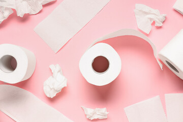 Rolls of toilet paper on pink background