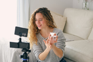 Vlogger recording makeup tutorial for social media blog