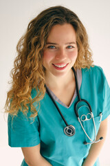 Smiling medical worker with stethoscope in studio