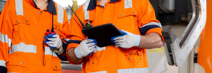 Engineer man and woman talking and discussion about robot arms technology intelligence and innovation while looking digital tablet at factory, people meeting and check machine robot, industry concept.