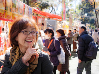 An older japanese woman smiling at a festival - 629245596