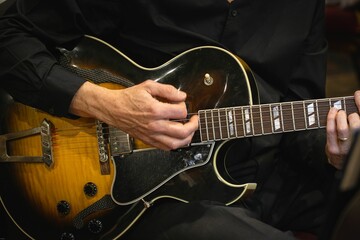 Closeup shot of a guitarist playing his guitar.