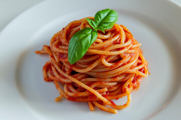 Dish with spaghetti tomato and basil