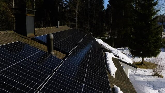 Aerial view of solar panels on a roof on a sunny winter day