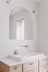 Fototapeta na wymiar Interior shot of a modern, minimalist bathroom, featuring a white sink and countertop