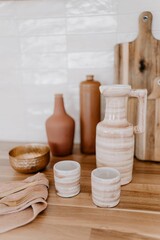 Rustic kitchen countertop with a selection of ceramic pots and bowls on display