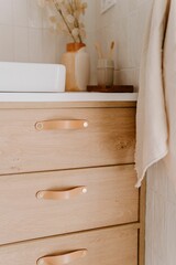 Obraz na płótnie Canvas Modern bathroom features a stylish wooden vanity with ample storage and a pristine white sink