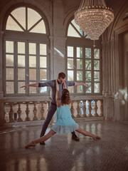 Graceful ballerina with partner dancing in palace