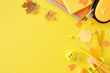 Dive into the world of education. Top view photo of school materials, autumn leaves, letters on yellow background with empty space for promo or text