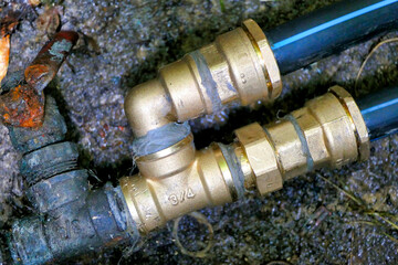 Brass joint connector attached to the old and new water pipe 
