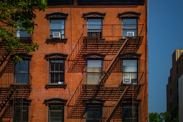 Old Brownstone building exterior with meta fire escape