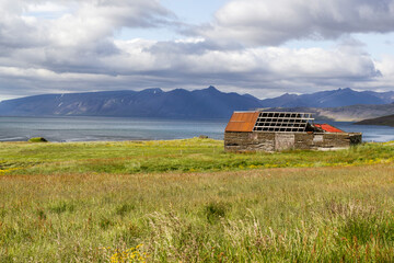 an rotten farm house at a scenic valley near Vesturbyggð, iceland