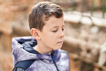 Blond child smiling confident breathing at street