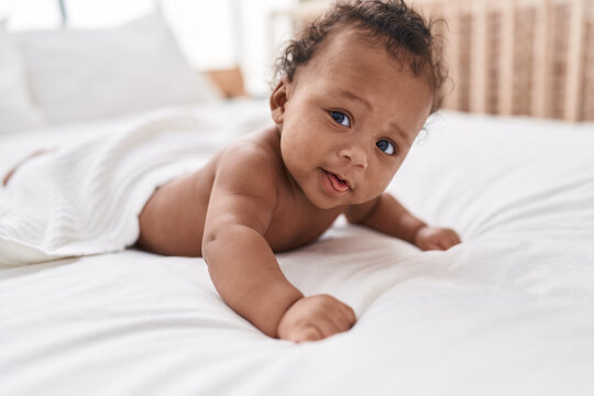 African american baby relaxing on bed at bedroom
