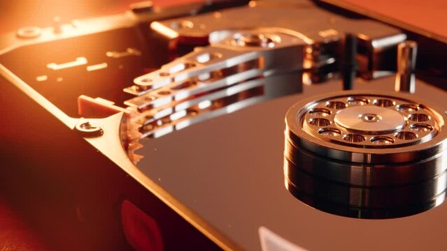 Closeup of the hard disk drive mechanism on blurred background illuminated with red lights