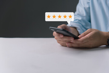 Customer review satisfaction feedback survey concept, man hand pressing on smartphone screen with...