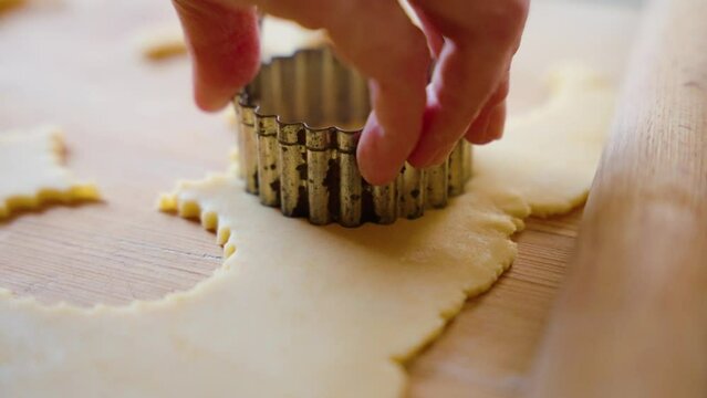 Cutting out cookies from shortbread dough.