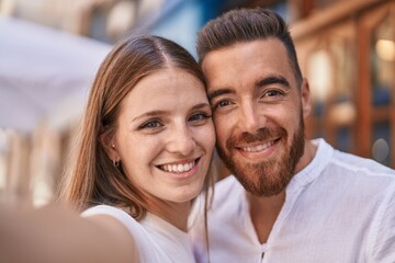 Man and woman couple smiling confident make selfie by camera at street