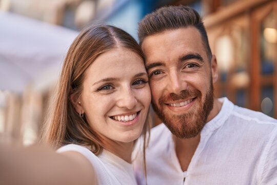Man and woman couple smiling confident make selfie by camera at street