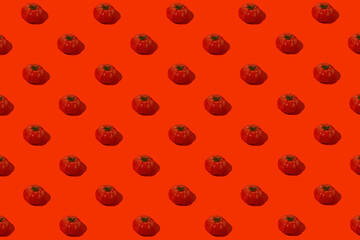 Creative pattern made of fresh tomatos on bright red background. Healthy food concept.