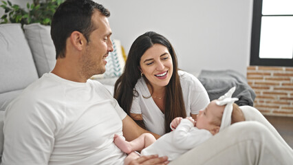 Fototapeta premium Family of three bonding sitting on the sofa at home