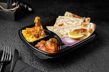 Chicken Biryani with buttered chicken and parotta bread meal