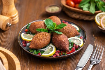 Plate of the Middle Eastern dish, kibbeh with lemons