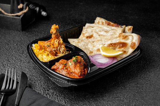 Chicken Biryani with buttered chicken and parotta bread meal