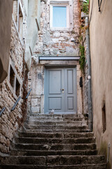 Fototapeta na wymiar street in old town in Rovinj with stairs and bird Seagull