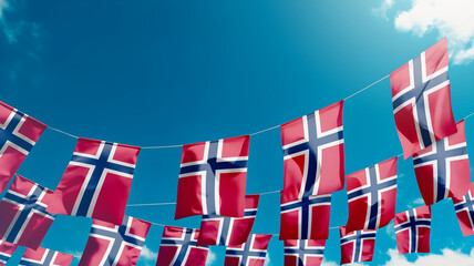 Flag of Norway against the sky, flags hanging vertically