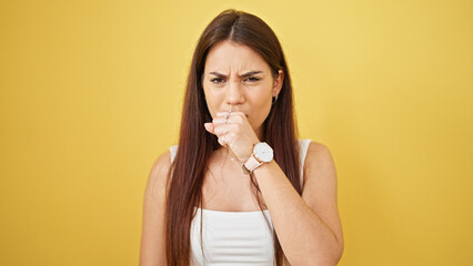 Young beautiful hispanic woman coughing over isolated yellow background