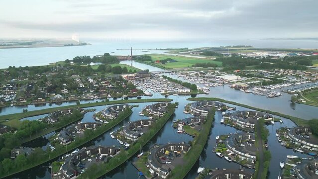 Aerial of the Wouda pumping station in Lemmer, Netherlands alongside the sea and the green field
