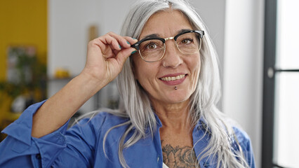 Middle age grey-haired woman business worker smiling confident at office