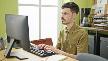 Young hispanic man business worker using computer working at office