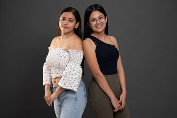 Portrait of two positive hispanic girls