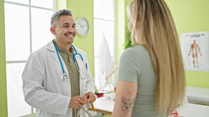 Man and woman dietician and patient speaking at the clinic