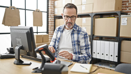 Middle age man ecommerce business worker using computer at office