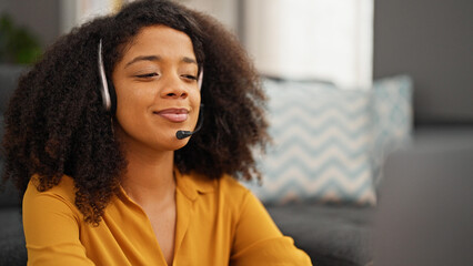 African american woman call center agent smiling working at home