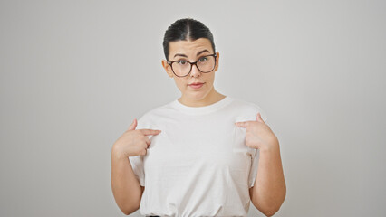 Young beautiful hispanic woman pointing herself over isolated white background