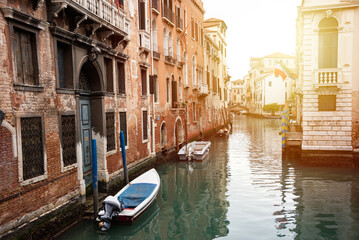 Fototapeta na wymiar Narrow canal in Venice, Italy with boats