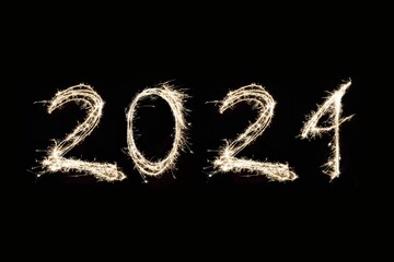 Fireworks display spelling out the word 2024 on black background
