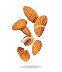 Whole and cracked almonds close-up in the air on a white background