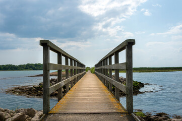 wooden footbridge across water. Perspective.