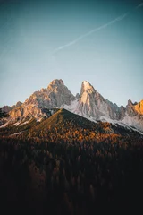 Foto op Plexiglas Dolomieten Stunning vertical shot of the majestic Dolomites mountains illuminated by the golden sunset light