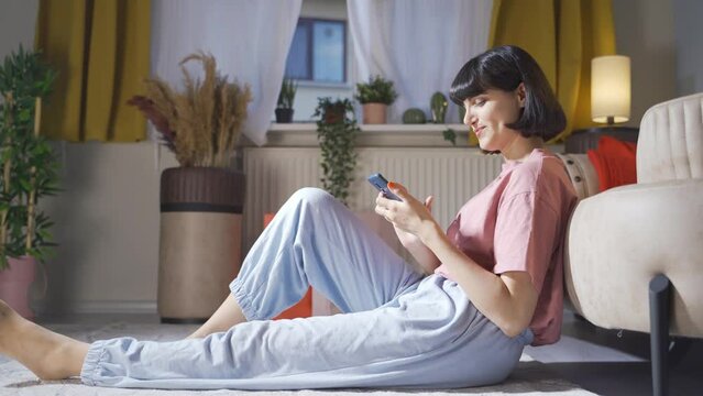 Woman using phone with happy expression. The woman is enjoying it.