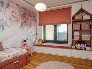 Cozy girl's bedroom featuring a single bed with a pink bed frame and coordinating furniture