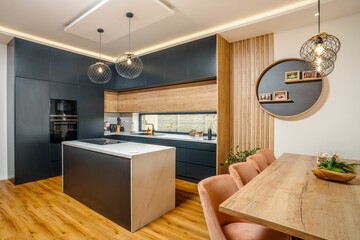 Modern kitchen with a combination of black cabinets, white marble and wooden accents