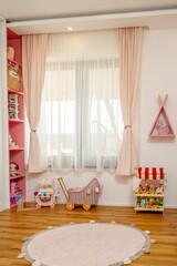 Colorful and airy kid's bedroom featuring a pink and white themed furniture set